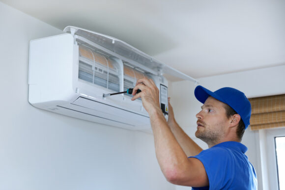 Hvac,services, ,technician,installing,air,conditioner,on,the,wall