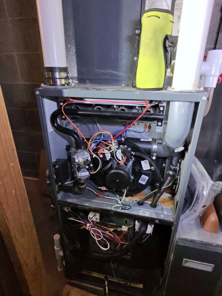 The inner wires of a dismantled HVAC unit being worked on