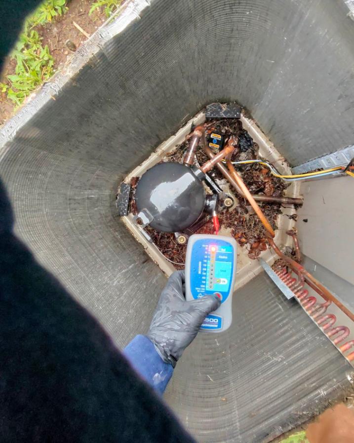 A first-person view from a contractor using a scanner on an open HVAC unit